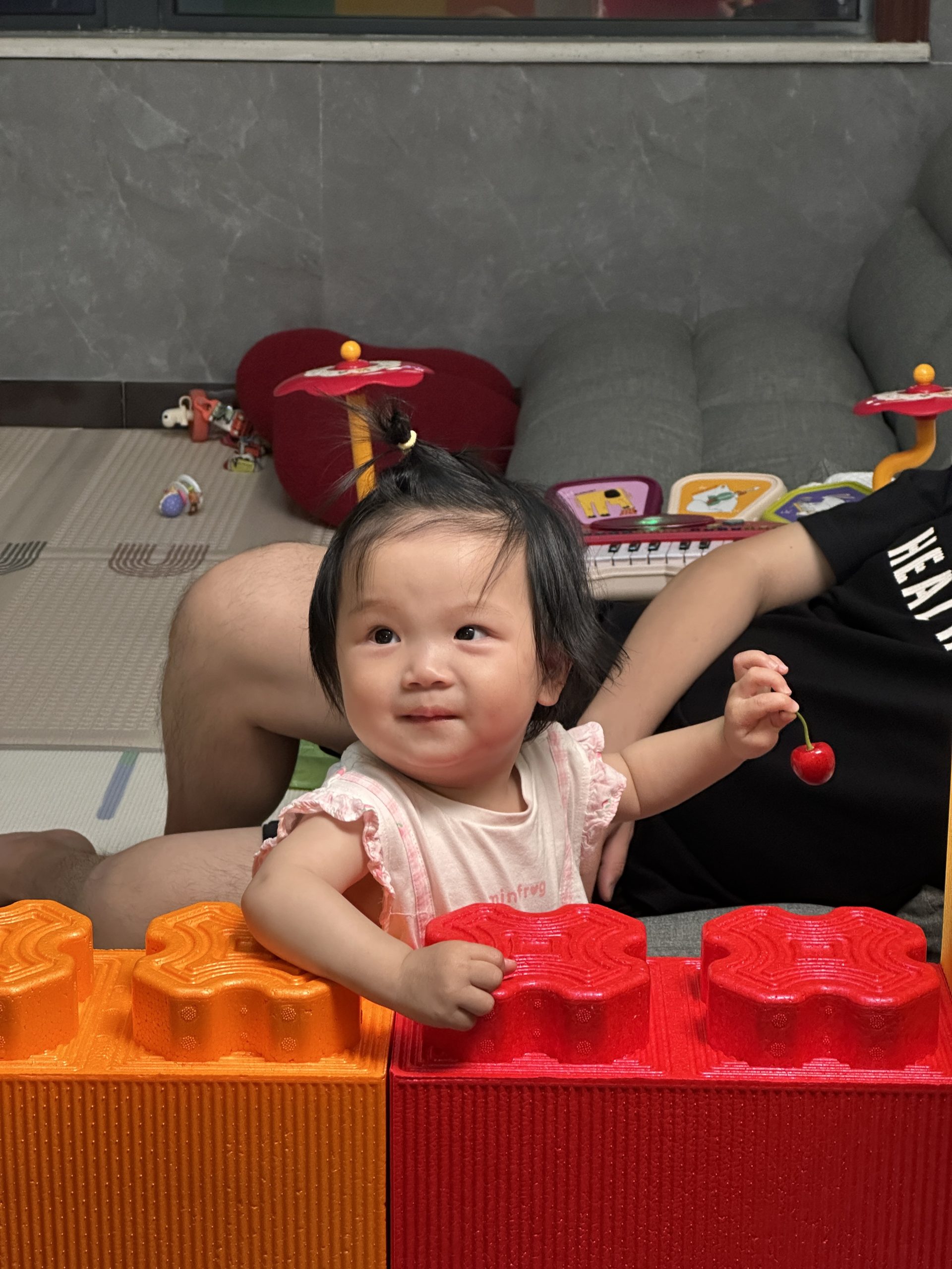 The baby is in the foam building block enclosure.